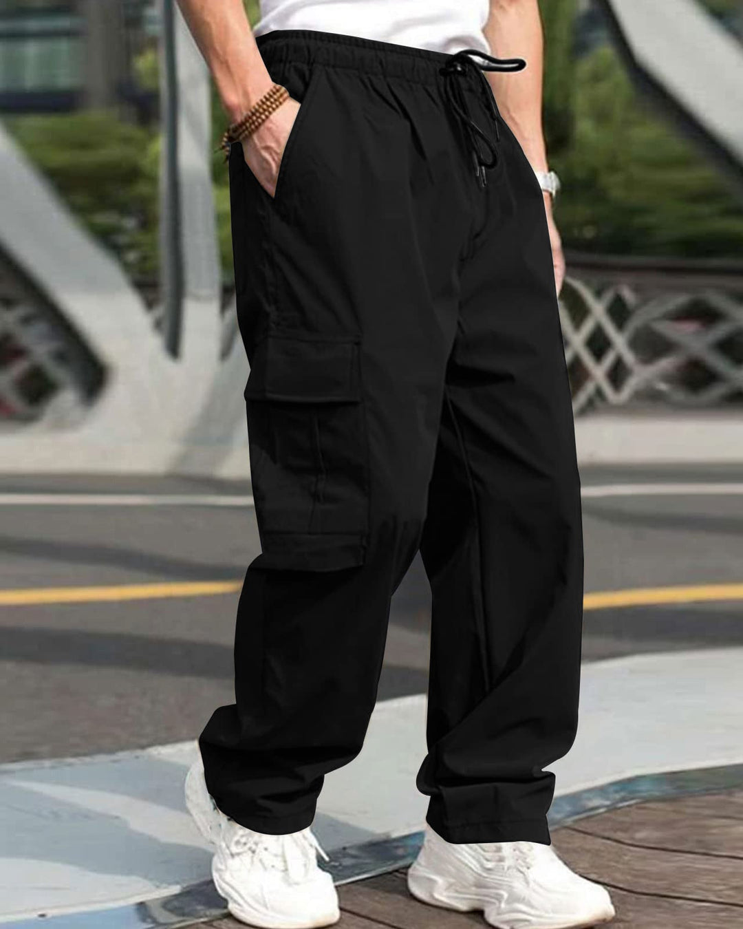 Person wearing black cargo pants with a blurred background