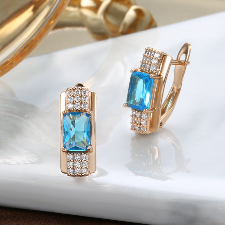 Pendientes de mujer de oro rosa con rosa azul natural y a la moda