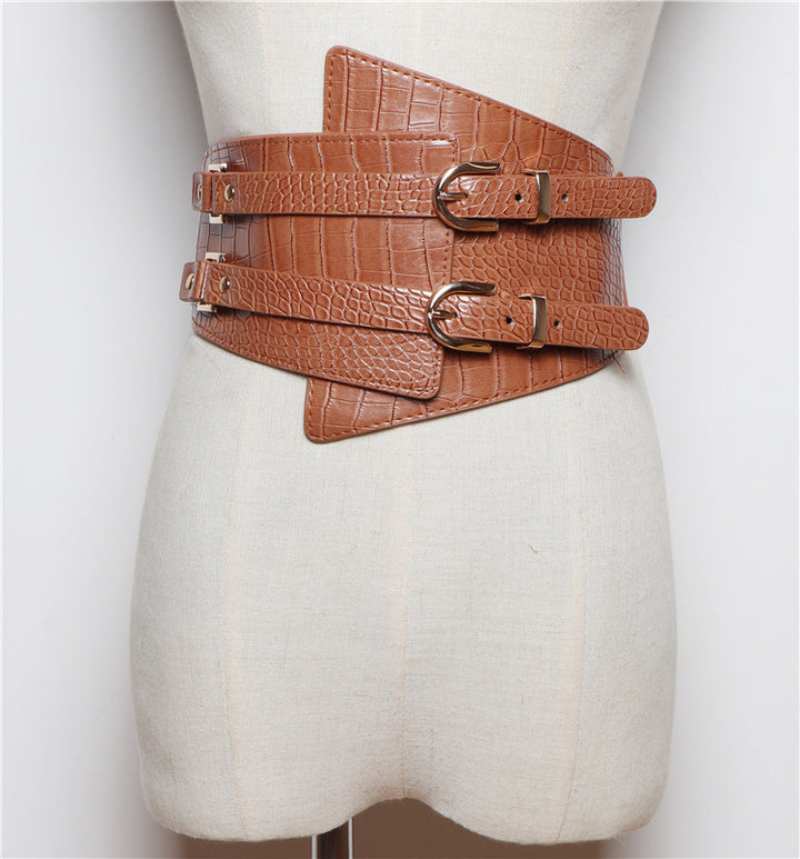 Brown leather belt with multiple buckles on a mannequin torso against a white background