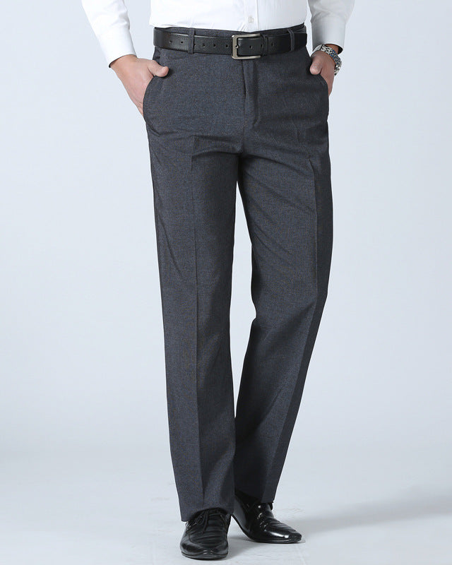 Gray dress pants worn with a white shirt and black shoes on a light gray background