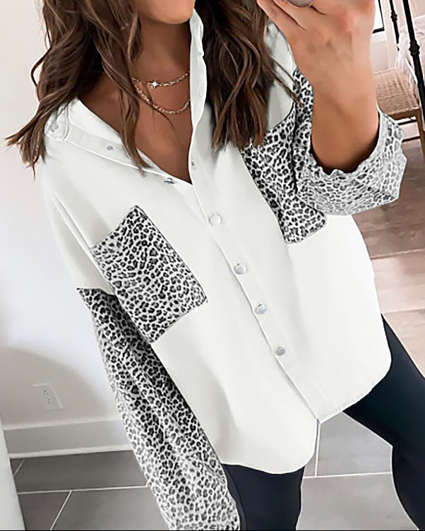 Woman wearing a white shirt with leopard print accents in a room.