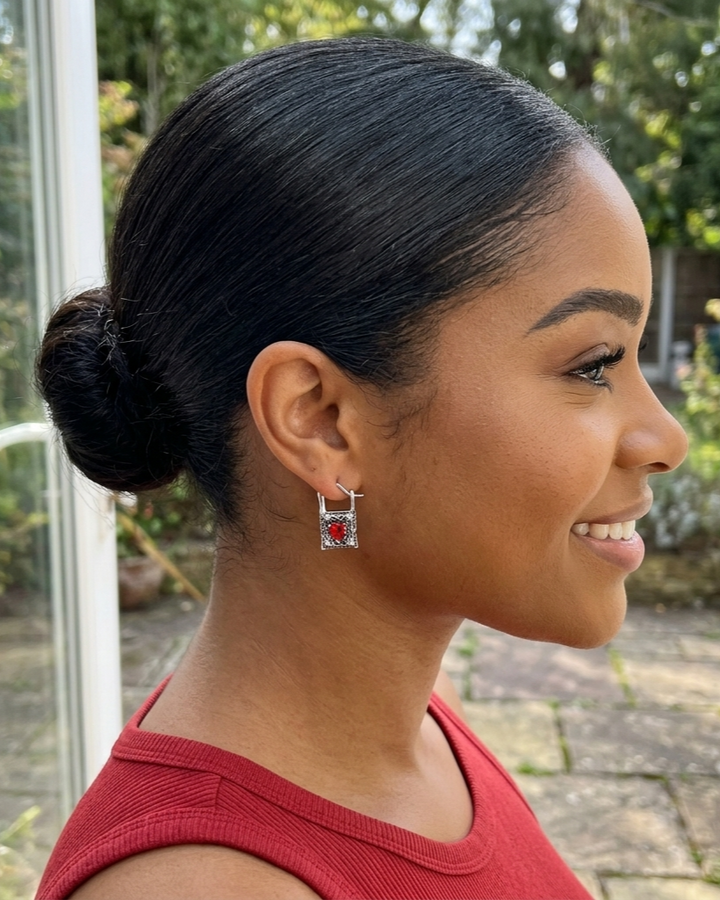 Woman with styled hair and red top outdoors
