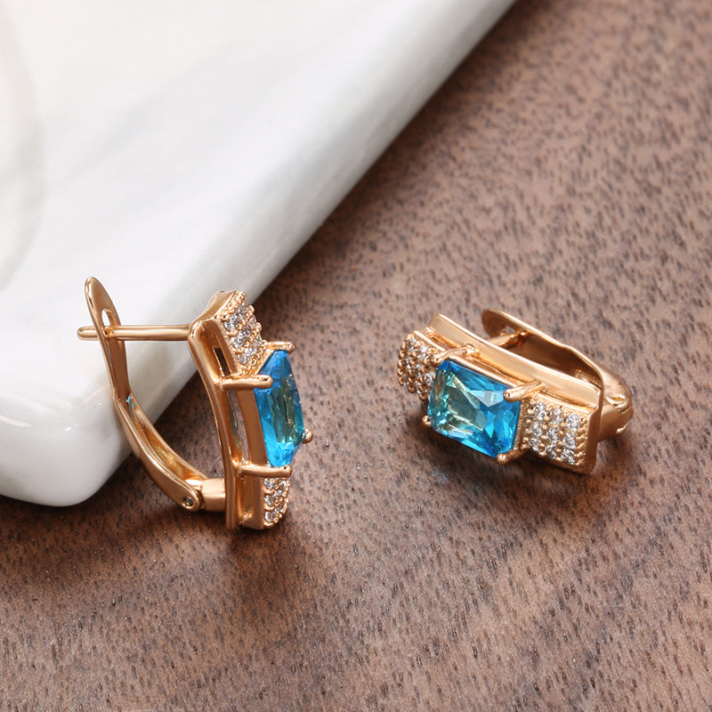 Pendientes de mujer de oro rosa con rosa azul natural y a la moda