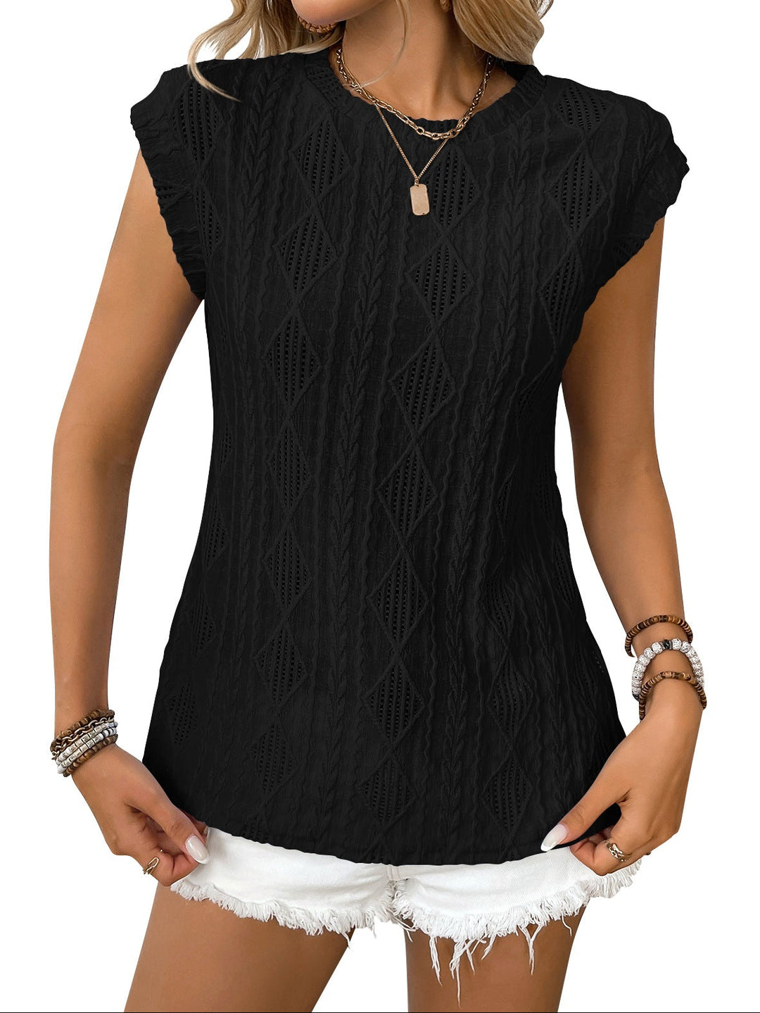 Woman wearing a black sleeveless top with a textured pattern on a white background