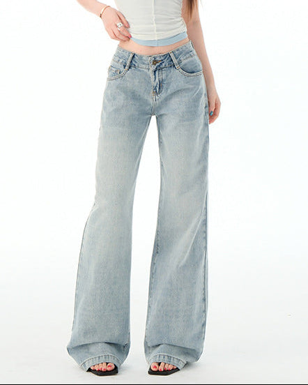 Woman wearing light blue jeans and a white sleeveless top on a white background