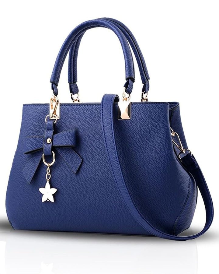 Blue handbag with a bow and star charm on a white background