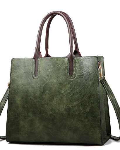 Green handbag with brown handles on a white background