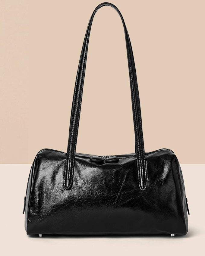 Black handbag on a beige background with 'LAIKE' branding.
