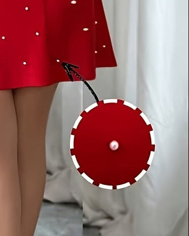 Woman in a red dress taking a mirror selfie in a room with white walls and gray floor.