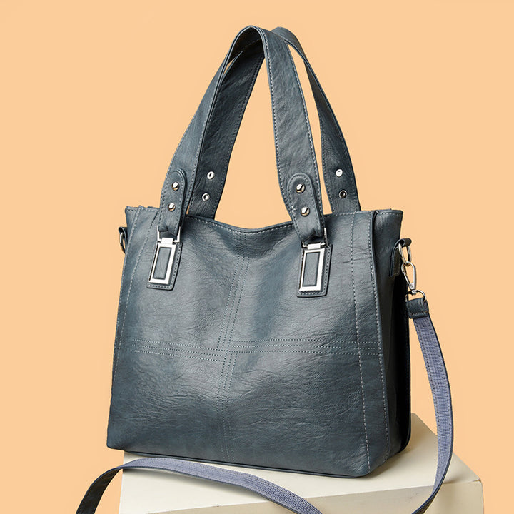 Blue handbag with a strap on a beige background