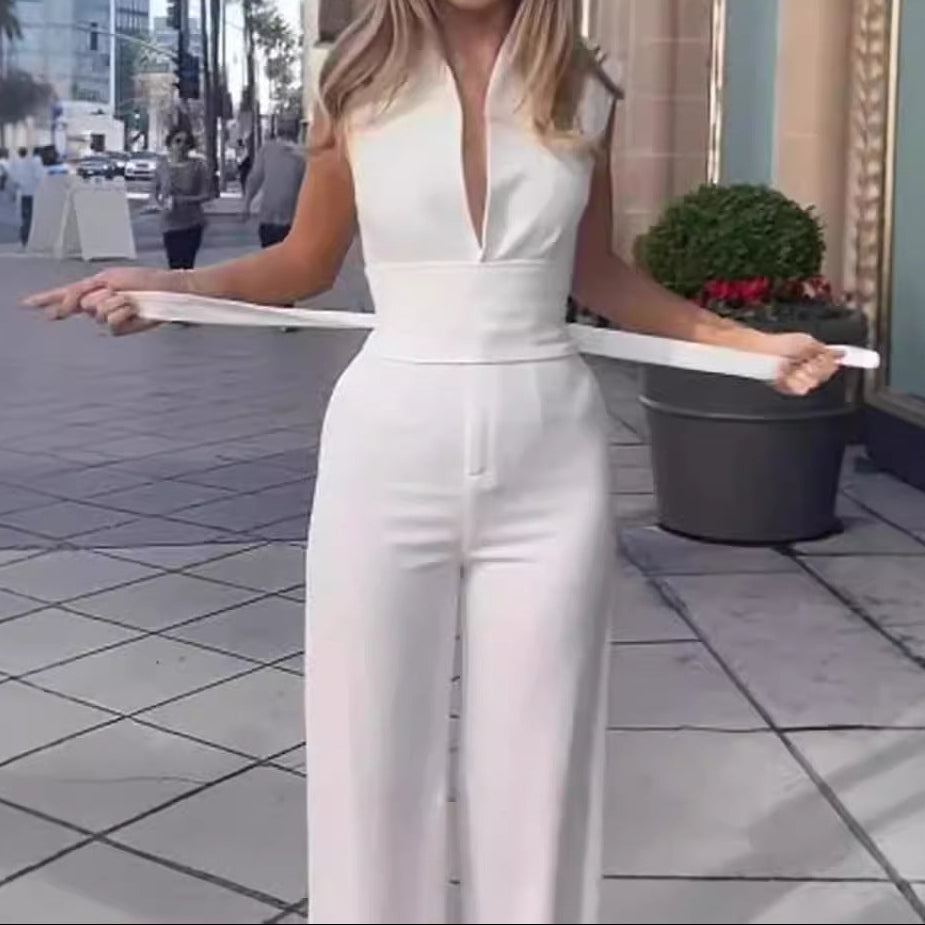 Woman in a white jumpsuit holding a white hoop on a city street.