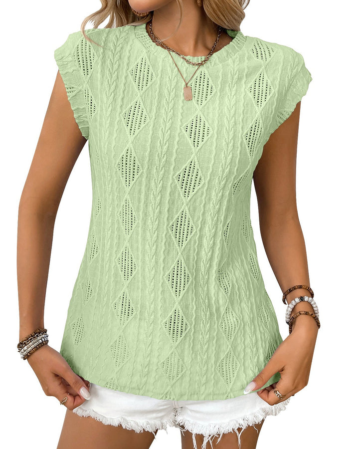 Woman wearing a light green knitted top with a white background
