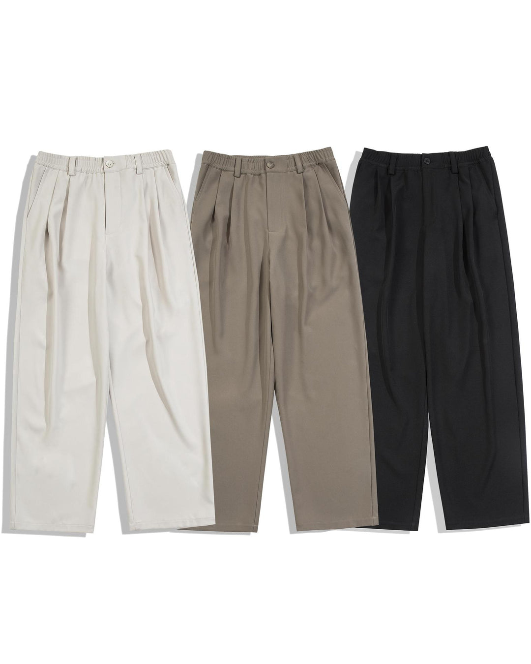 Three pairs of pants in beige, brown, and black on a white background