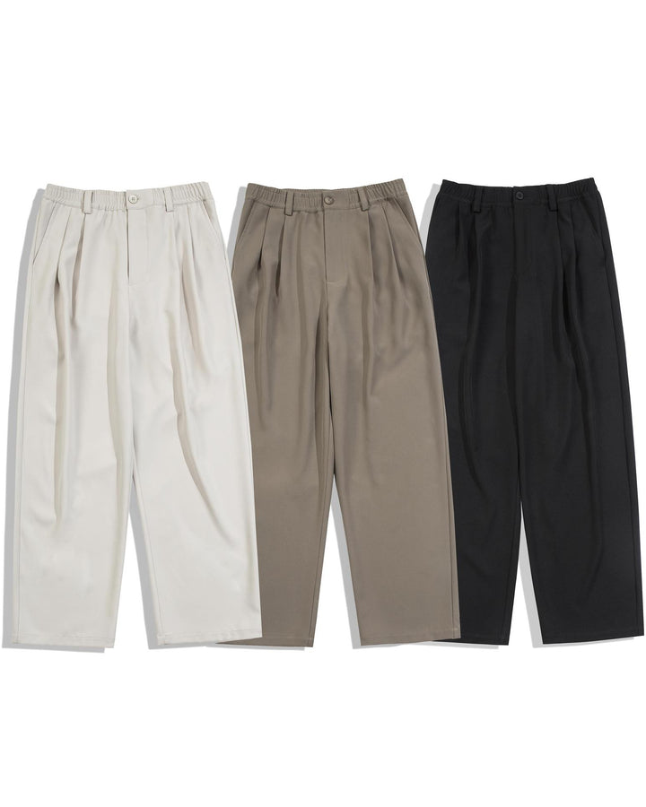 Three pairs of pants in beige, brown, and black on a white background